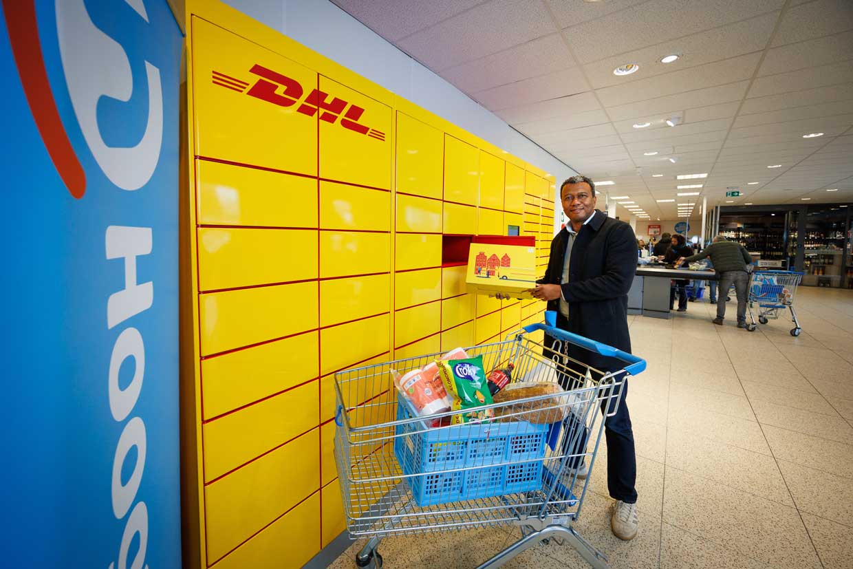 Harrie Treurniet van DHL bij een pakketautomaat van Hoogvliet