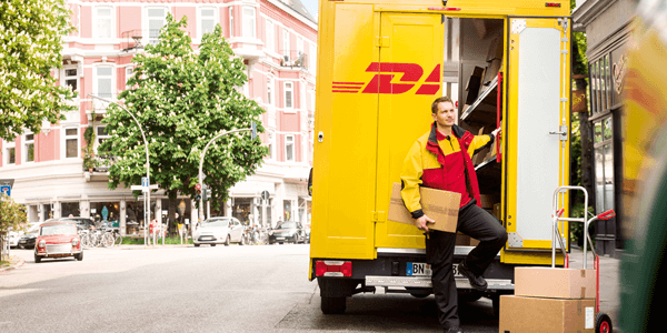 DHL bezorger bij bestelauto