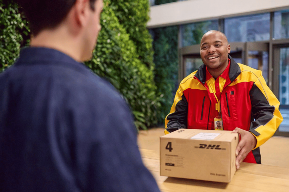 DHL courier delivering a parcel