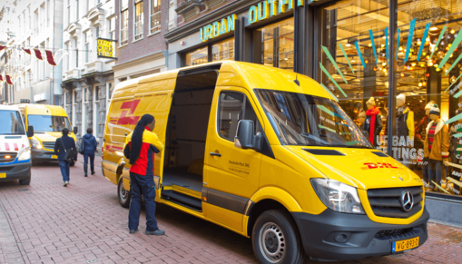 DHL deliverer near an electric van DHL deliverer near an electric van